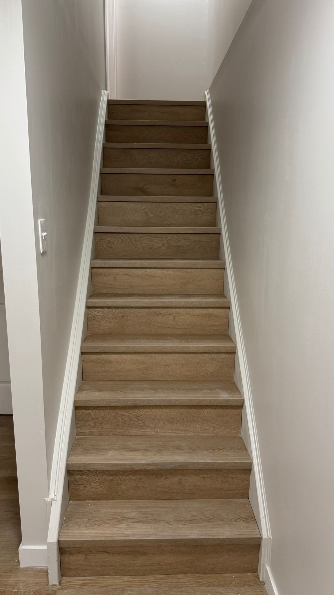 Symmetrical staircase with oak treads and white stringers